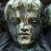 Detail of relief showing the head of an angel, covered in cobwebs, The Grange Cemetery, Edinburgh.