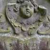 Detail of relief showing the head and wings of an angel on a headstone, The Howff Burial Ground, Dundee.