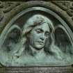 Detail of relief showing the face and wings of an angel, New Dean Cemetery, Edinburgh.