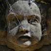 Detail showing head of stone angel, covered in cobwebs.