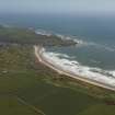 General oblique aerial view of Cruden bay centred on Cruden Bay Golf Courses, looking to the NNE.