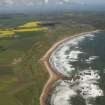 General oblique aerial view of Cruden bay centred on Cruden Bay Golf Courses, looking to the N.