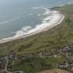 General oblique aerial view of Cruden bay centred on Cruden Bay Golf Courses, looking to the SSE.