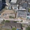 Oblique aerial view of building construction within Aberdeen Royal Infirmary, looking to the NNW.