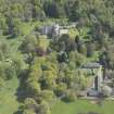 General oblique aerial view of Kemnay House with adjacent farm house, looking to the SSE.