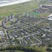 General oblique aerial view of Aberdeen Seaton Housing estate centred on the Regent Walk Tower blocks with Pittodrie Stadium in the background, looking to the SE.