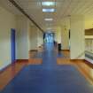 Interior. View looking along the central corridor, with viewing balcony to main sports hall viewing to right, taken from west.