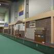 Interior. Oblique view looking along the west wall of the carpet bowls green, showing score boards and lockers.