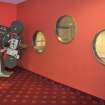 Interior view of the Magnum Leisure Centre, Irvine showing detail of old cinema projector and porthole opening within theatre foyer.