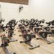 Interior. View of "spin'' class bikes within former squash court.