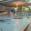 Interior. View looking south east across swimming pool hall, with pool extension beyond.