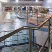 Interior. View from raised walkway looking north across the swimming pool hall.