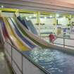 Interior. View looking south along water slides within swimming pool hall.