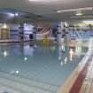 Interior. View looking south over the splash pool with lightwell to main concourse above and main pool hall beyond.