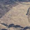 Oblique aerial view of the remains of the township buildings, field boundaries and cultivation, looking SSE.