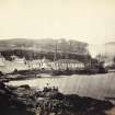 View of Caol Ila Distillery and surroundings, at Port Askaig, Islay. View is from South East. 
Titled: '86. Caol Isla Distillery Islay-'
PHOTOGRAPH ALBUM NO 186: J B MACKENZIE ALBUMS vol.1