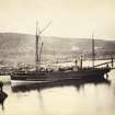 General view showing moored boat named 'Jura' and manse in background at Scalasaig Harbour, Scalasaig, Colonsay.
Titled: '89. "Jura" at Colonsay Quay, Manse in the distance.'
PHOTOGRAPH ALBUM, NO 186: J B MACKENZIE ALBUMS vol.1