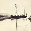 General view of steamship called 'Jura' being moored at Scalasaig Harbour, Scalasaig, Colonsay.
Titled: '88. "Jura" at Colonsay Quay.'
PHOTOGRAPH ALBUM, NO 186: J B MACKENZIE ALBUMS vol.1