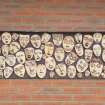 View of clay faces displayed on the exterior of the music block.