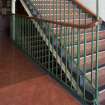 Interior. Detail of bannister on mezzanine level staircase.