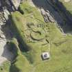 Oblique aerial view of Nybster Broch and Nybster Commemorative Monument, looking E.