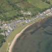 General oblique aerial view of the Hamilton Terrace area of Lamlash with the remains of the harbour in the bay, looking to the N.