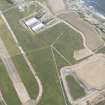 Oblique aerial view of Dounreay Airfield and store houses, looking to the WSW.