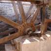 View of the waterwheel with axel bearing, spoke fixing and spoke, from a Standing Building Survey, Glamis Mill, Glamis, Angus.