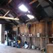 Interior view of the sawmill showing the post and beam construction of its south wall, from a Standing Building Survey, Glamis Mill, Glamis, Angus.