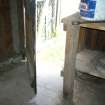 Interior view showing door and workbench, from a Standing Building Survey, Glamis Mill, Glamis, Angus.