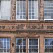 Detail of carved name 'Milton House Public School' at first floor level on front elevation of Milton House School, 86 Canongate, Edinburgh.
