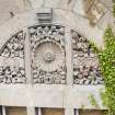 Elevated view from crane, showing carved tympanum over window.