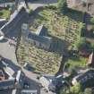Oblique aerial view of St Serf's Church with the Glasgow University excavations on the edge of the churchyard, looking NNW.