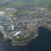 Oblique aerial view of Fraserburgh, Fraserburgh Harbour, Kinnaird Lighthouse and New Lighthouse, looking SW.
