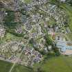 Oblique aerial view of Longside, the Old Parish Church, Parish Church and Longside School, looking NE.