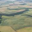 General oblique aerial view of the cropmarks of the fort at The Chesters, Spott, looking NNE.