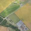 Oblique aerial view of the windmill and cropmarks of the ring ditch at Sandend, looking SW.