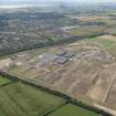 Oblique aerial view of the Diageo bonded warehouses at Cluny Bond under construction with Kirkcaldy beyond, looking SW.