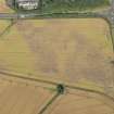 Oblique aerial view of the cropmarks of the barrow and pits, looking NW.