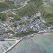 Oblique aerial view of Gardenstown and harbour, looking to the SE.