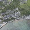 Oblique aerial view of Gardenstown and harbour, looking to the SE.