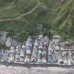 Oblique aerial view of Gardenstown and sea wall, looking to the SE.