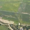 Oblique aerial view of the cropmarks of the settlements, unenclosed houses and pit alignment at Congalton, looking S.