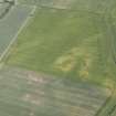 Oblique aerial view of the cropmarks of the settlements, unenclosed houses and pit alignment at Congalton, looking E.