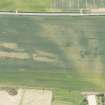 Oblique aerial view of the cropmarks of the unenclosed houses and ring ditch, looking S.