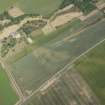 Oblique aerial view of the cropmarks of the settlements, pit alignment and unenclosed houses at Congalton, looking NE.