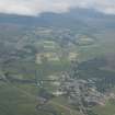 General oblique aerial view of Kingussie with Newtonmore beyond, looking WSW.