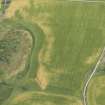 Oblique aerial view of the cropmarks of the enclosure, possible round house and pits, looking NE.