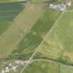 Oblique aerial view of the cropmarks of the rig and furrow, looking NE.