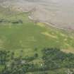 Oblique aerial view of fish traps and the cropmarks of the enclosures at Tarbat House, looking S.